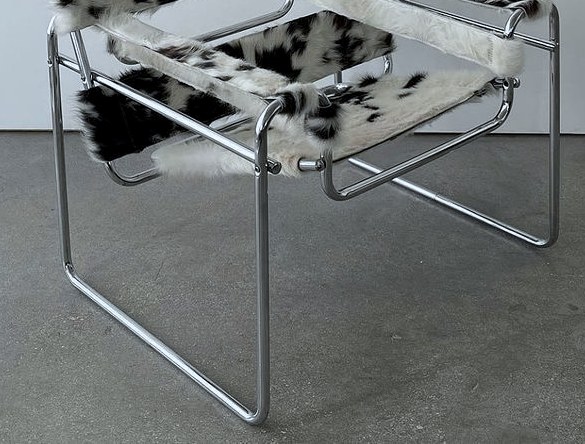 Tubular chrome chair on a grey concrete floor