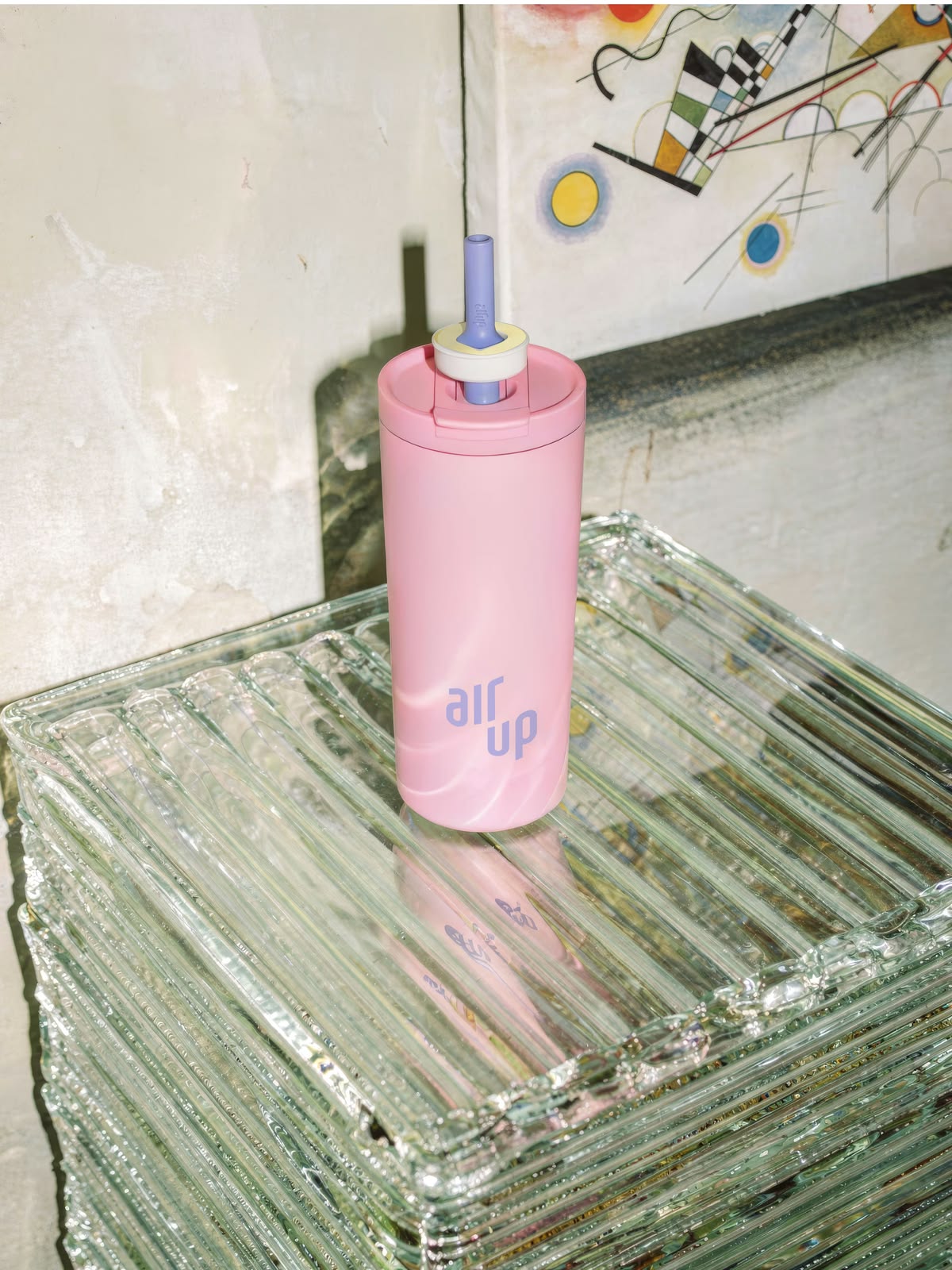 Pink bottle standing on stacked glass