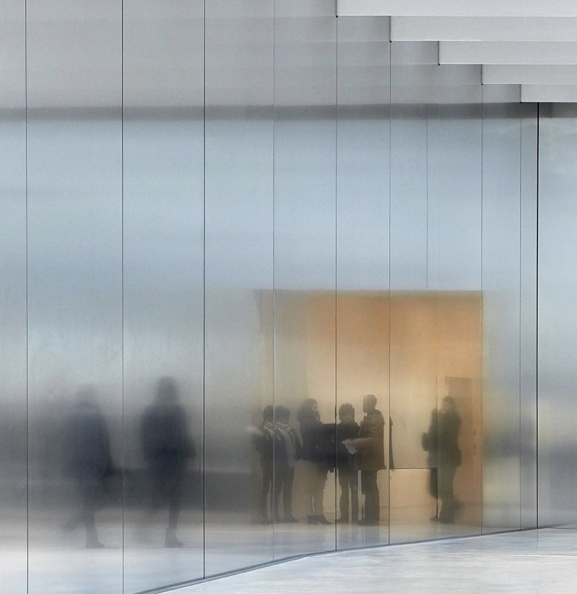 Figures blurred behind frosted glass
