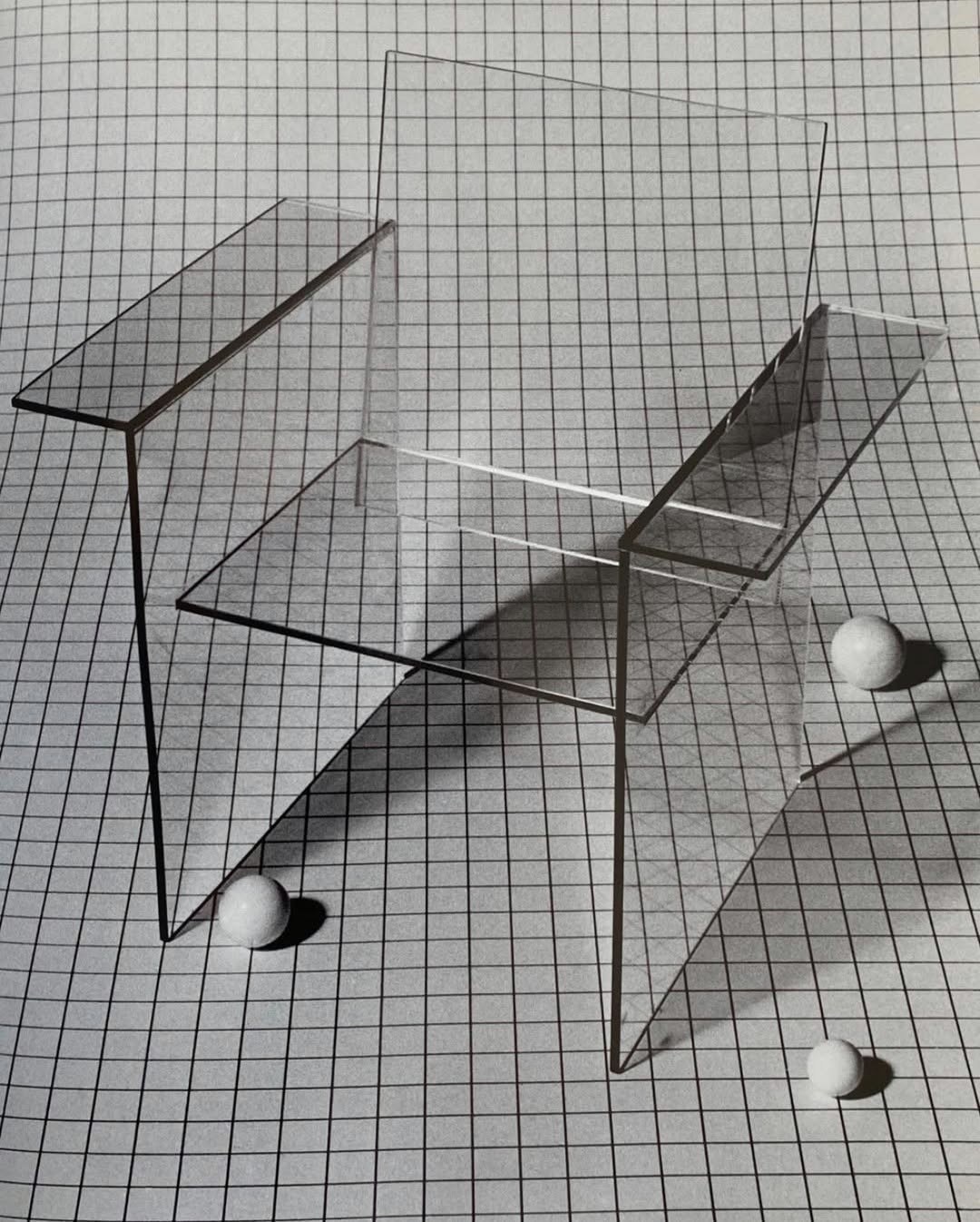 Transparent acrylic chair against a fine tiled grid