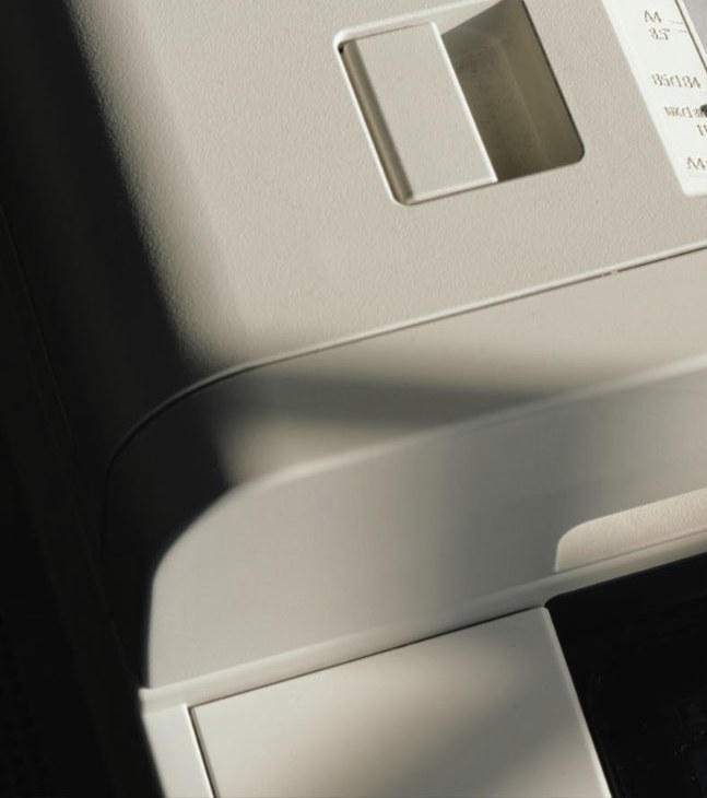 Close detail of the curved surface and controls of an office printer